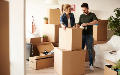 couple-packing-stuff-among-plenty-cardboard-boxes_329181-18184